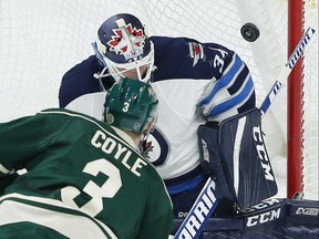 Winnipeg Jets goalie Michael Hutchinson blocks a shot by the Wild's Charlie Coyle in the first period of their game Saturday night in St. Paul, Minn.