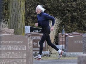 Ed Whitlock runs in a cemetery near his home in Milton, Ont.