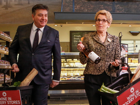 Premier Kathleen Wynne and Finance Minister Charles Sousa at a announcement in February about wine being sold in grocery stores. There’d be press events for the uncorking of each bottle sold in grocery stores, if the Ontario government could swing it, David Reevely writes.
