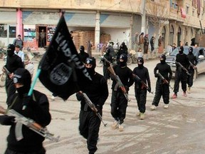 This undated file image posted on a militant website on Tuesday, Jan. 14, 2014, which has been verified and is consistent with other AP reporting, shows fighters from the al-Qaida linked Islamic State of Iraq and the Levant (ISIL), now called the Islamic State group, marching in Raqqa, Syria