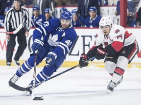 Toronto Maple Leafs' Nazem Kadri, left, protects the puck from Ottawa Senators' Jean-Gabriel Pageau during first period of the preseason game in Halifax on Sept. 26, 2016.