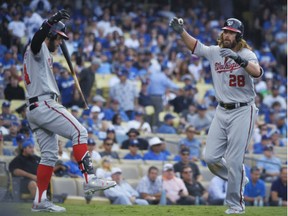 Washington Nationals' Jayson Werth, left, celebrates after his home run with Bryce Harper during the ninth inning in Game 3 of National League Division Series against the Dodgers in Los Angeles on Monday,