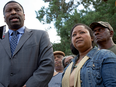 Mississippi NAACP President Derrick Johnson, left, talks to the media on behalf of Stacey and Hollis Payton, right, parents of a high school student who allegedly had a noose thrown around his neck by white students, in Wiggins, La., Monday, Oct. 24, 2016.