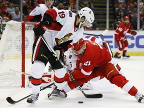 Derick Brassard, left, of the Ottawa Senators tries to make a play with the puck while being defensed by Detroit Red Wings' Tomas Tatar during NHL action Monday night at Joe Louis Arena in Detroit. The Red Wings were 5-1 winners.