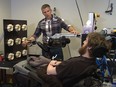 University of Pittsburgh Medical Center researcher Robert Gaunt touches the finger of a robotic arm, causing Nathan Copeland, a quadraplegic, to feel that sensation in his own finger.