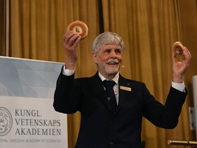 Thors Hans Hansson, member of the Nobel Committee for Physics, uses a bagel and a bun to visualize his explanations during a press conference to announce the winners of the 2016 Nobel Prize in Physics at the Royal Swedish Academy of Sciences in Stockholm on Oct. 4, 2016.