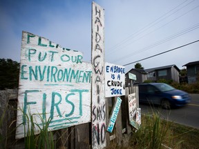 Handmade anti-pipeline signs are seen on the side of a road in the First Nations village of Old Massett, British Columbia.