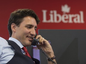 Prime Minister Justin Trudeau works the phones at Liberal headquarters in Ottawa.