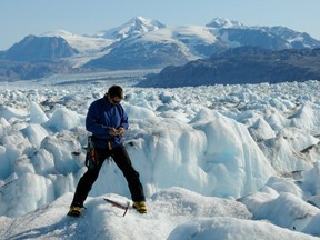 n Aug. 27, 2009 photo provided by Leigh Stearns shows University of Maine professor Gordon Hamilton, in Kangerdlugssuaq Glacier, East Greenland.