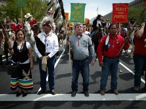 Members of the Cowboy and Indian Alliance march down Independence Avenue while demonstrating against the proposed Keystone XL pipeline in April 2014.