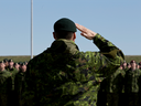 Commanders salute during National Day of Honour ceremonies at CFB Edmonton in Edmonton, Alta., on Friday, May 9, 2014. 