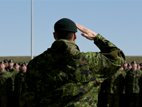 Commanders salute during National Day of Honour ceremonies at CFB Edmonton in Edmonton, Alta., on Friday, May 9, 2014.
