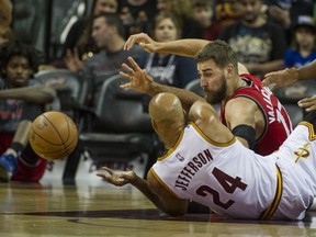 Cleveland Cavaliers' Richard Jefferson battles for the ball with Toronto Raptors' Jonas Valanciunas during  NBA preseason game in Cleveland, on Thursday.