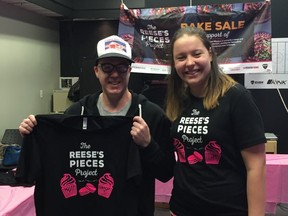 Reese Precourt (right) sets up for her bake sale to raise money to support the homeless in her community of Winnipeg, Manitoba.