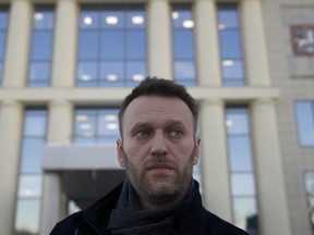 Russian opposition leader Alexei Navalny leaves a court house in Moscow, Russia, Tuesday, Feb. 17, 2015