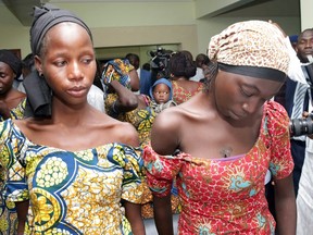 Two of the 21 girls freed by Boko Haram last week look downcast as they meet Nigerian leaders.