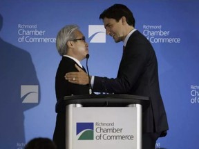 Liberal leader, now prime minister Justin Trudeau, is greeted at a 2015 Richmond Chamber of Commerce lunch by the event sponsor, Paul Oei