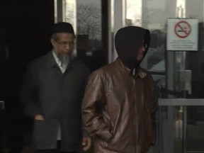 Mohammad Uddin (L) leaving court with son Kadir Abdul in April 2016.