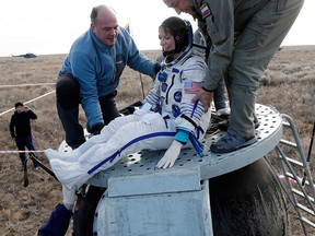 U.S. astronaut Kate Rubins is helped from a Soyuz space capsule after landing with two other astronauts in Kazakhstan on Oct. 30, 2016.