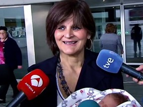 In this screen grab taken from video on Tuesday, Oct. 18, 2016, Lina Alvarez leaves Lucas Augusti Hospital with her new born baby, in Madrid, Spain.