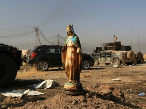 A statue of Virgin Mary sits in a street in Bartella, Iraq, Sunday shortly after the town was liberated from ISIL.