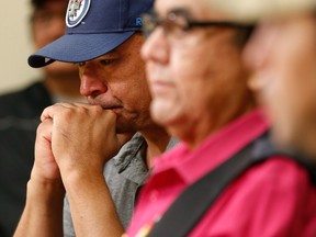 Norway House resident Leon Swanson weeps at a press conference in Winnipeg, Friday, August 26, 2016 where Manitoba's former aboriginal affairs minister Eric Robinson, centre, announced Swanson and David Tait Jr., right, were switched at birth in 1975 when their mothers gave birth at Norway House Indian Hospital.