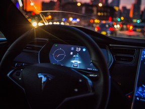 An instrument panel with the Tesla Motors Inc. 8.0 software update illustrates the road ahead using radar technology inside a Model S P90D vehicle in the Brooklyn borough of New York, U.S., on Tuesday, Sept. 20, 2016. The latest overhaul of the car's operating system, known as Tesla 8.0, biggest change is how Autopilot shifts towards a heavier reliance on its radar than its camera to guide the car through traffic. Photographer: Christopher Goodney/Bloomberg ORG XMIT: 671908107