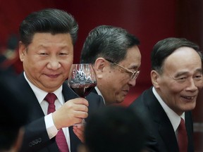In this Friday, Sept. 30, 2016 file photo, Chinese President Xi Jinping, left, makes a toast to high-ranking officials at a dinner marking the 67th anniversary of the founding of the People's Republic of China at the Great Hall of the People in Beijing.