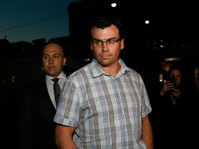 Ken Pagan (right) arrives at Toronto Police's 52 Division with his lawyer, Tyler Smith, on Oct. 6.