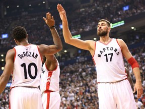 DeMar DeRozan congratulates Raptors teammate Jonas Valanciunas after a scoring play in the second quarter of their game againsdt the Detroit Pistons at the Air Canada Centre in Toronto on Wednesday night.