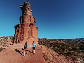 Hikers at the Lighthouse rock formation in the Palo Duro Canyon State Park in Canyon, Texas.