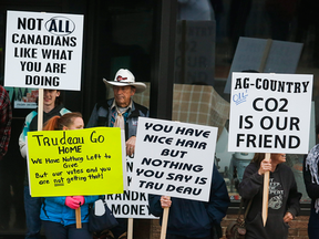 Protesters gather outside the venue where Prime Minister Justin Trudeau attended a byelection campaign event in Medicine Hat, Alta., Thursday, Oct. 13, 2016.