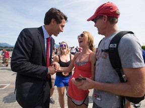 Liberal Leader Justin Trudeau, left, greets a young woman while on the campaign trail in Vancouver in 2015.