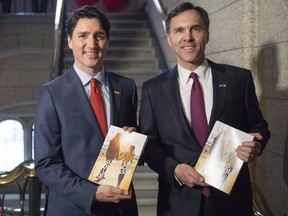 Prime Minister Justin Trudeau, left, walks with Minister of Finance Bill Morneau as he arrives to table the budget on Parliament Hill in Ottawa on March 22.