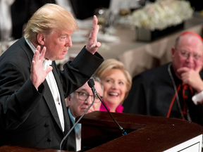 Donald Trump speaks while  Hillary Clinton and Cardinal Timothy Dolan, Archbishop of New York, listen at the Alfred E. Smith Memorial Foundation dinner, Thursday, Oct. 20, 2016, in New York.