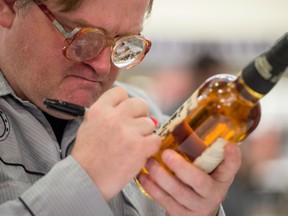 Mike Smith, a.k.a. 'Bubbles' signs autographs during a launch event for Trailer Park Boys Liquormen's Old Dirty Canadian Whisky at the LCBO store on Queen Quay in Toronto, Ontario, Thursday, October 6, 2016.