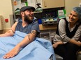 Ret. Marine Sgt. John Peck, 31, shares a laugh with his fiancee Jessica Paker, 29, during an appointment at Brigham and Women's Hospital in Boston. Peck received a double arm transplant in August after being on the wait list for two years.