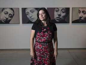 Wanda Nanibush poses for a portrait in front of Will Gorlitz's piece "Genre IV, XVI, VII, VIII, XIII, II" as a part of her new exhibit Toronto: Tributes + Tributaries at the Art Gallery of Ontario.