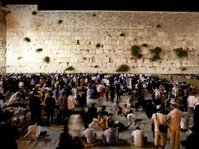 Religious Jews sleep and pray at the Western Wall in Jerusalem's Old City during the annual 9th of Av memorial for the destruction of ancient Jerusalem on July 19, 2010, in Jerusalem.