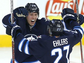 Jets rookie Patrik Laine celebrates his second goal against the Toronto Maple Leafs with winger Nikolaj Ehlers during their game in Winnipeg on Wednesday night. Laine finished the night with a hat-trick as the Jets won 5-4.