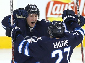 Winnipeg Jets right winger Patrik Laine, left, celebrates his second goal against the Toronto Maple Leafs with teammate Nikolaj Ehlers.