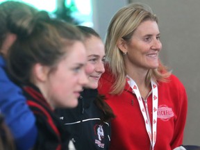 Olympic gold medalist Hayley Wickenheiser poses with young women at her annual Canadian Tire Wickenheiser Female World Hockey Festival opening day Friday at Winsport in Calgary.