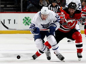 Toronto Maple Leafs forward Connor Brown fights off the New Jersey Devils' Jacob Josefson for the puck Wednesday during the Devils' 5-4 shootout win at Prudential Center in Newark, N.J.