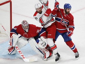 Montreal Canadiens goalie Carey Price keeps an eye on the play while Carolina Hurricanes' Viktor Stalberg sneak's in between Price and Greg Pateryn Thursday night in Montreal.