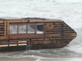 The scene that greeted a resident of Ireland's County Mayo while out for a walk on Sunday; a homemade tar-and-wood boat bobbing in the surf.