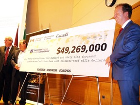 Laurentian University President and Vice-Chancellor Dominic Giroux looks on as Paul Lefebvre, MP for Sudbury, and Marc Serre, MP for Nickel Belt  unveil a cheque for $49,269,000 in funding for Laurentian University  in Sudbury, Ont. on Tuesday September 6, 2016.