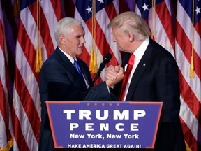 President-elect Donald Trump shakes hands with vice president-elect Mike Pence as he gives his acceptance speech during his election night rally in New York on Wednesday.