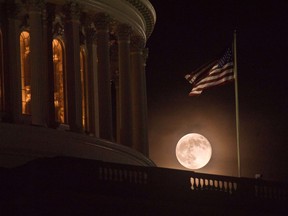 The full moon rises behind the US Capitol in Washington on June 23, 2013