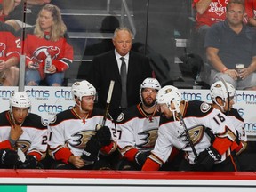 Randy Carlyle (in suit) stands behind the Anaheim Ducks bench in New Jersey on Oct. 18.
