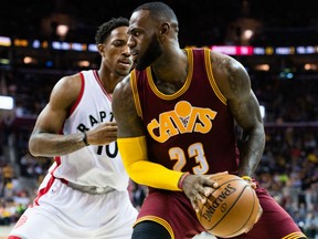 LeBron James of the Cavaliers duels for position with DeMar DeRozan of the Toronto Raptors during the second half at Quicken Loans Arena in Cleveland on Tuesday night. The Cavaliers edged the Raptors 121-117.